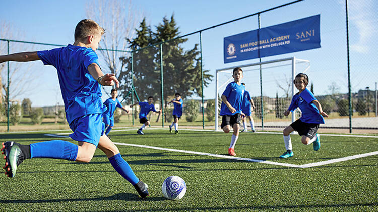 Teenagers play football at the Chelsea Football Academy at Sani Resort