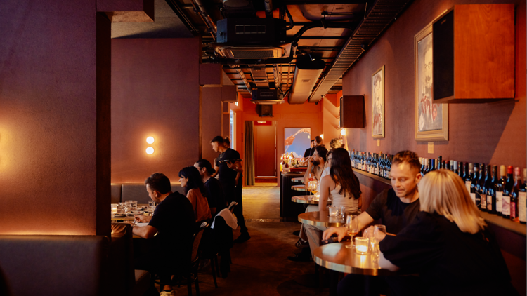 People enjoying a drink and dinner at Busby's