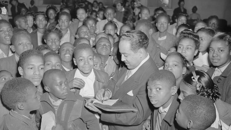 Langston Hughes stands in a crowd