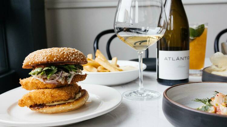 A variety of dishes and a bottle of wine on a table