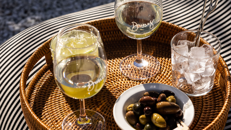 Drinks and olives on a rattan tray