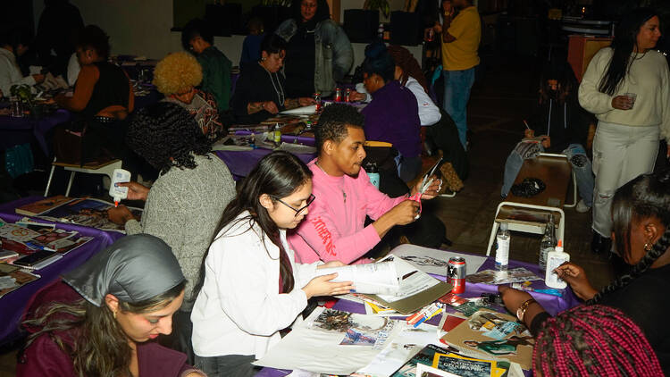 People sit at a table making crafts