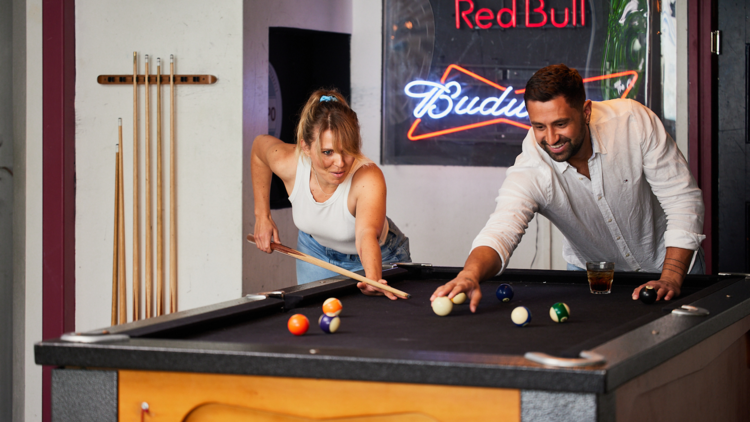 Two people playing pool