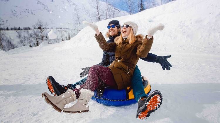 A couple snow tubing