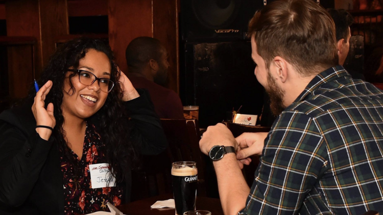 A man and woman at a speed dating event.