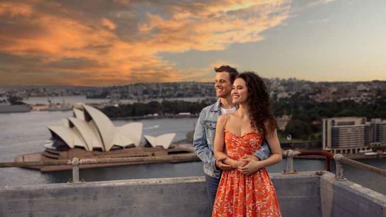 Tony and Maria share an embrace next to Sydney Opera House