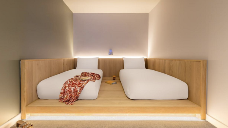 Room with two cocoon beds and soft led lighting in Zedwell Hotel