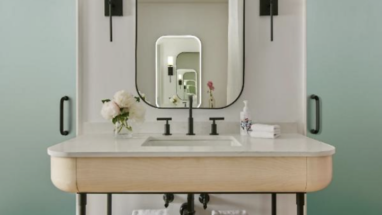 Spa bathroom with sink towel rack and mirror in virgin hotel nyc. 