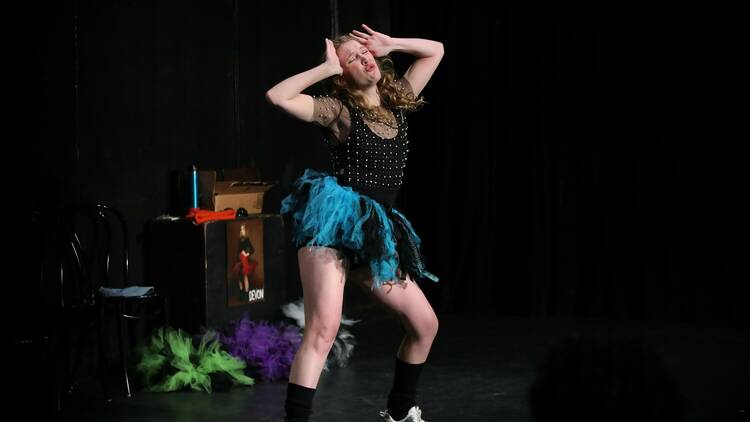 Woman dances on stage wearing a tutu