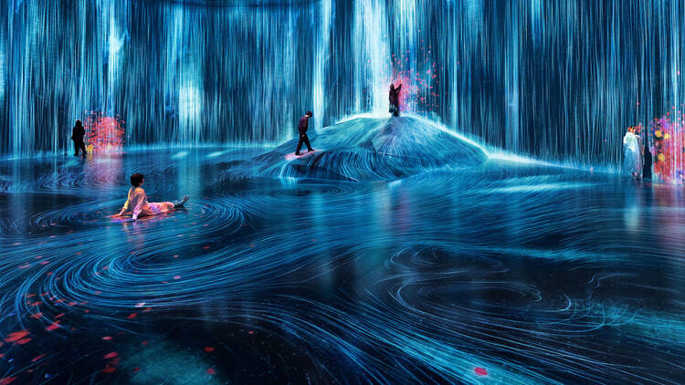 Universe of Water Particles on a Rock where People Gather at teamLab Borderless