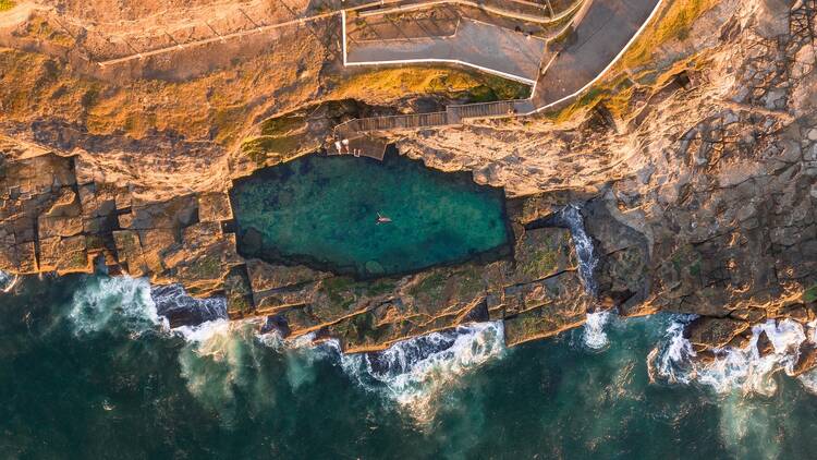 A rock pool on a cliff above the ocean