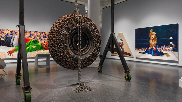 A sculpture including a giant tire, along with several paintings at The Brooklyn Museum.