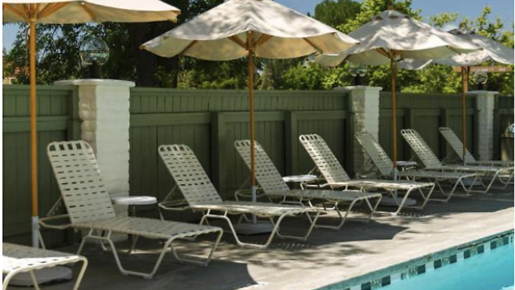 Poolside area at Hummingbird Inn with a row of sun loungers