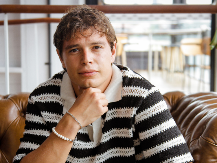 Carlos Sanson Jr sits with his hand under his chin