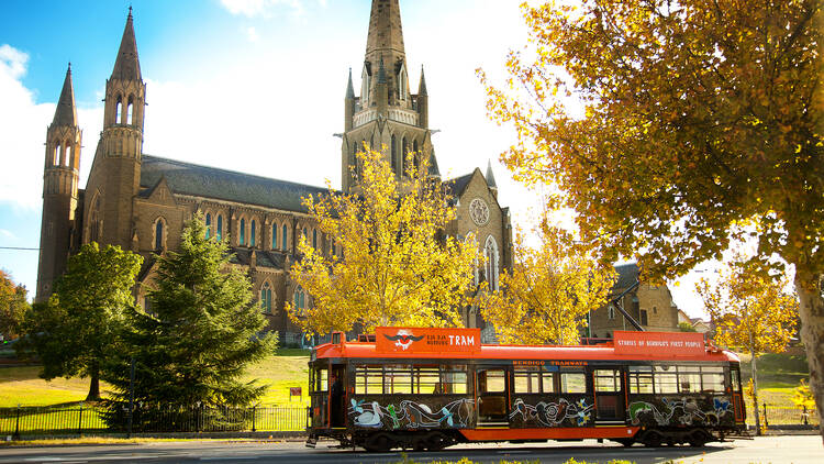 A tram in front of a church
