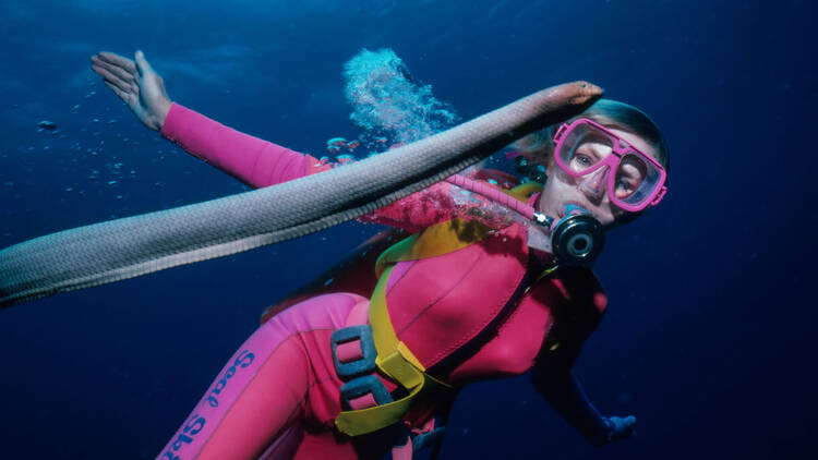 Valerie underwater diving with an eel