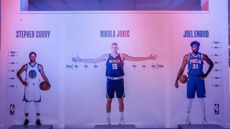 Life-size photos of NBA players with their measurements.
