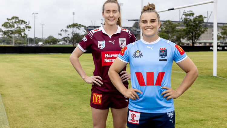 Two sportswomen standing (one in a maroon jersey and one in blue)