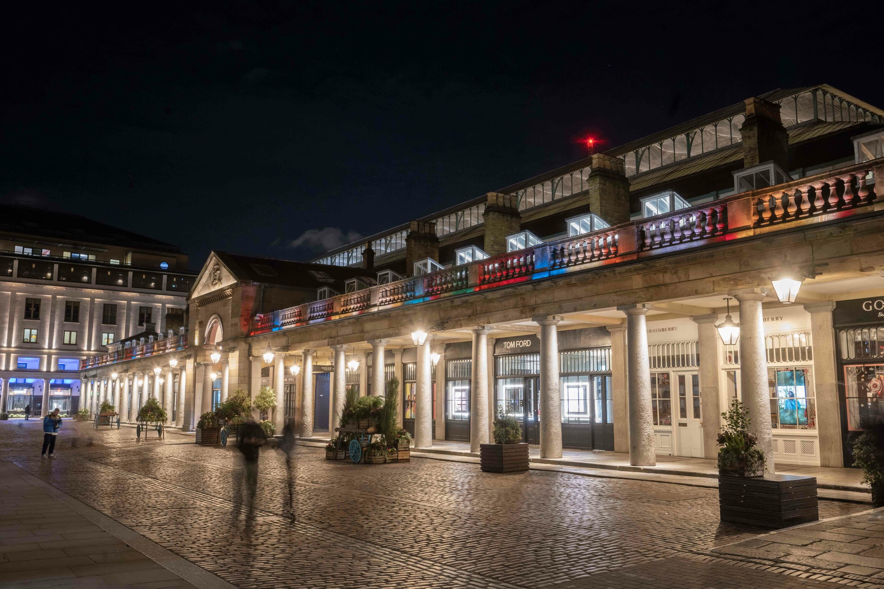 Rainbow coloured lights on the exterior of Covent Garden