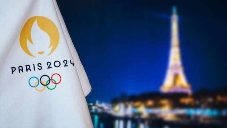 Paris 2024 flag with Eiffel Tower in background