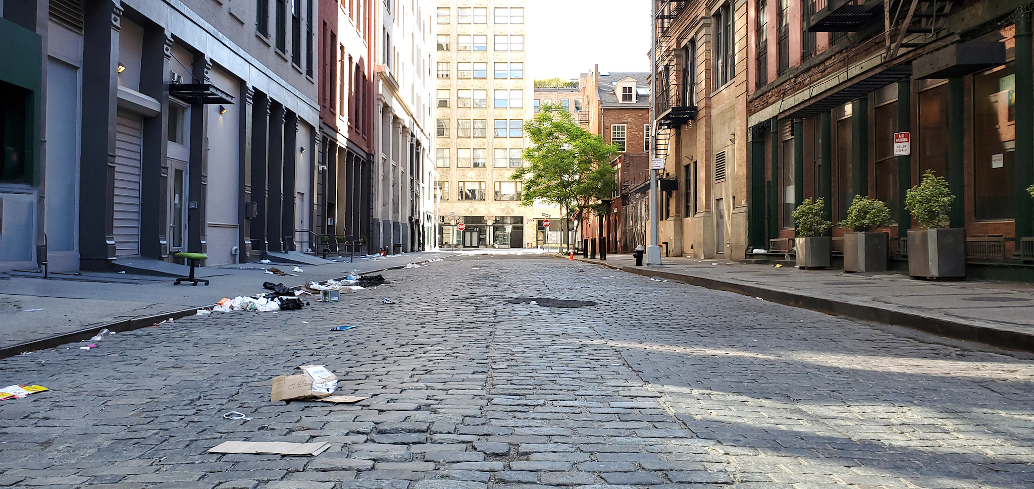 Empty view of Crobsy Street covered with trash in the NoHo neighborhood of Manhattan in New York City NYC