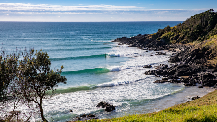 A lone surfer enjoys perfect waves at Crescent Head on the northern side of Racecourse Head.