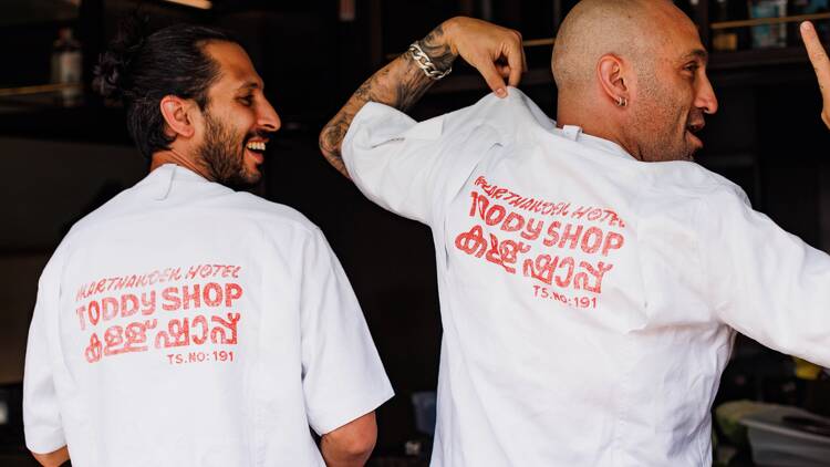Chef Mischa Tropp and Zachary Riggs wearing Toddy Shop T-shirts.