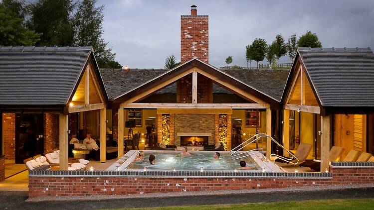 A pool in front of a cabin