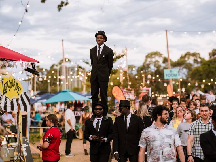 An outdoor festival with a circus acts