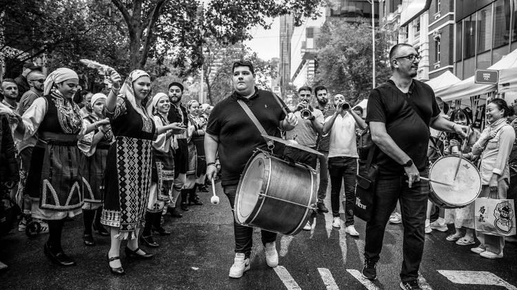 Performers drumming and dancing on the street. 