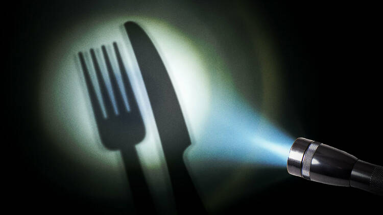 A torch shining a light on cutlery