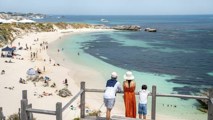 Family on a viewing platform looking at a beach