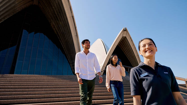 Three people walking down the steps of the Opera House