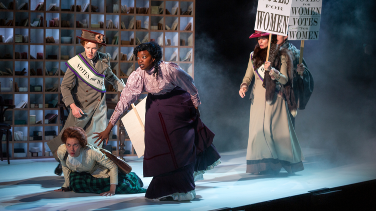 Actors onstage in The Dictionary of Lost Words portraying a women's suffrage protest