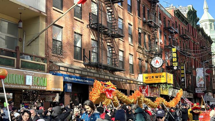A dragon dances through the crowd at NYC's Lunar New Year Parade in 2024.