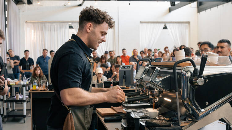 Axil's Jack Simpson participating in a coffee-making competition.