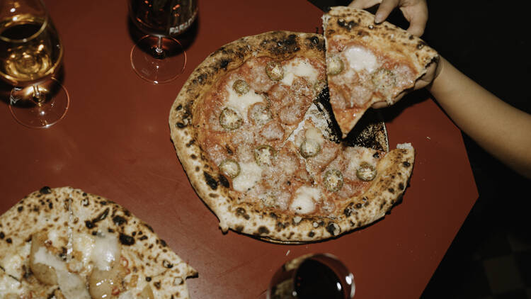 A pizza on a red table