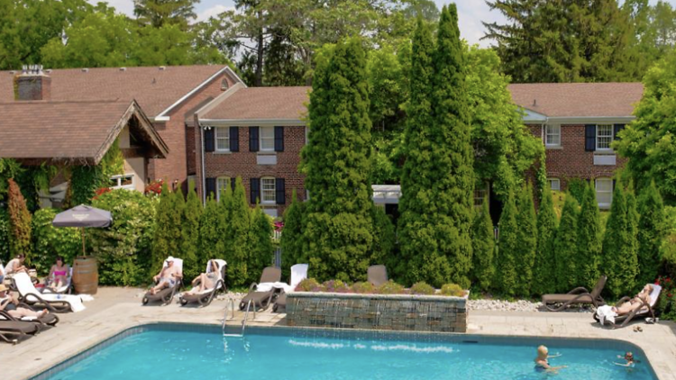 Guests swimming in the outdoor pool at the Pillar and Post Inn and Spa