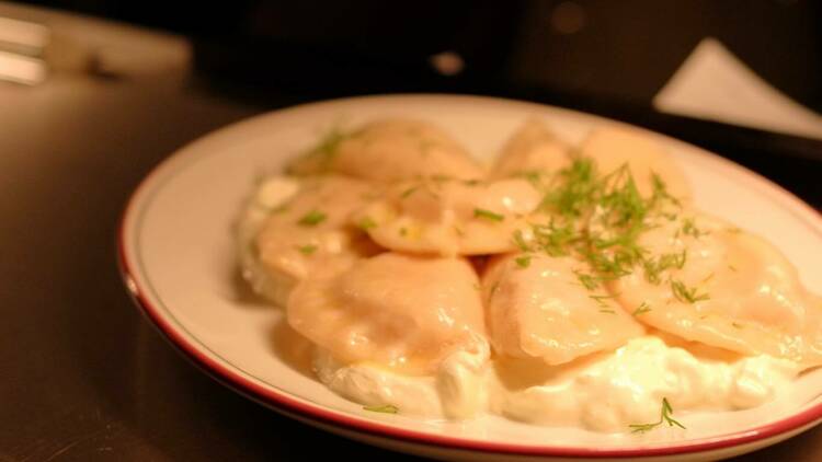 Pierogi dumplings with sour cream.