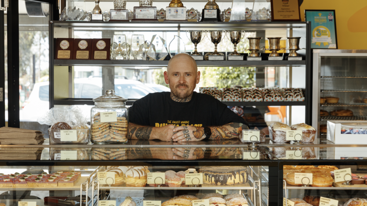 A chef standing behind his award-winning bakery counter