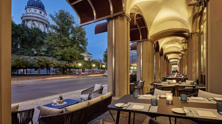 Outdoor terrace with dining area at Hotel Luc