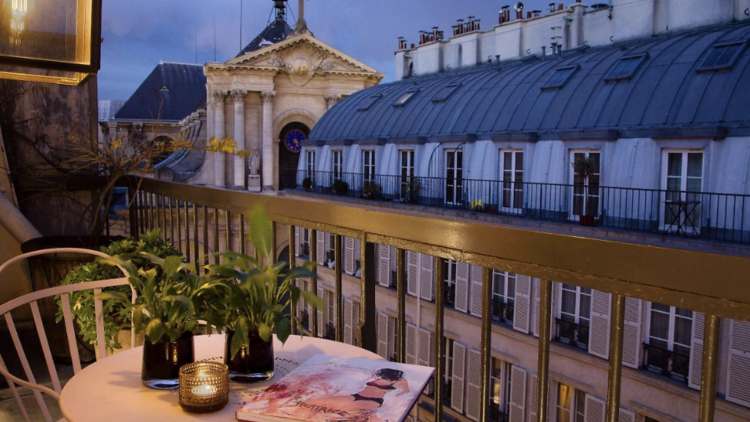 Balcony in Le Pradey Hotel overlooking historic buildings. 