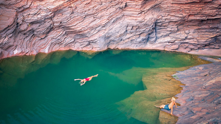 A couple swimming in a rock pool
