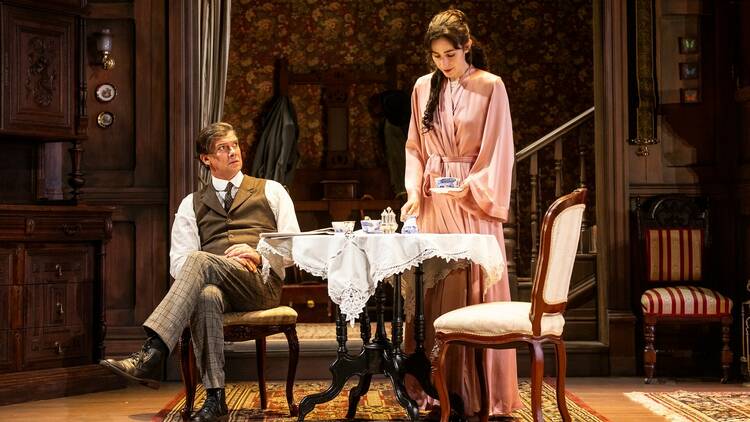 Geraldine Hakewill and Toby Schmitz having tea onstage in Gaslight