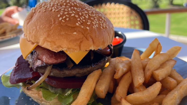 A big hamburger with chips.