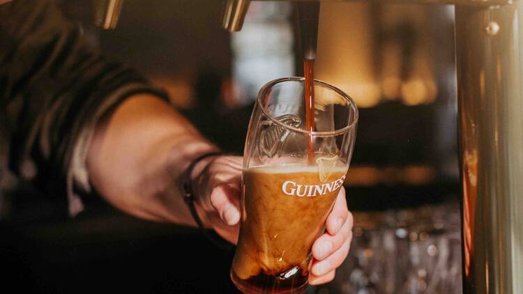 A pint of guinness being poured