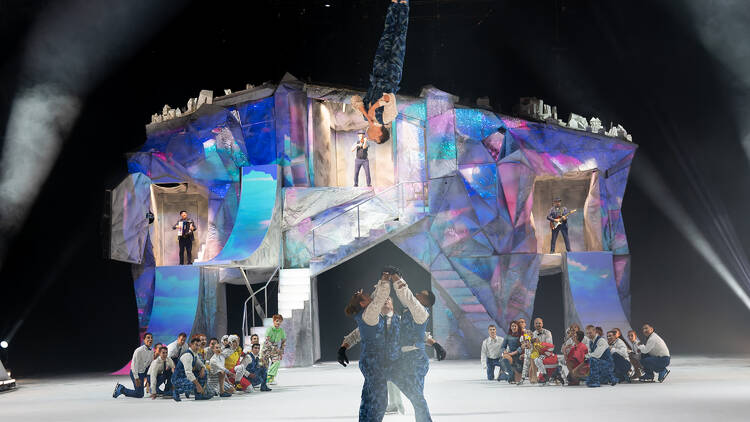 A person in the air as performers look on