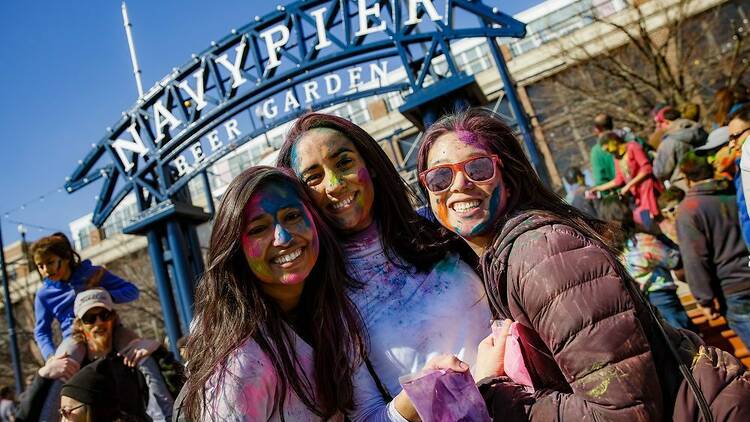 Three girls covered in colored powder
