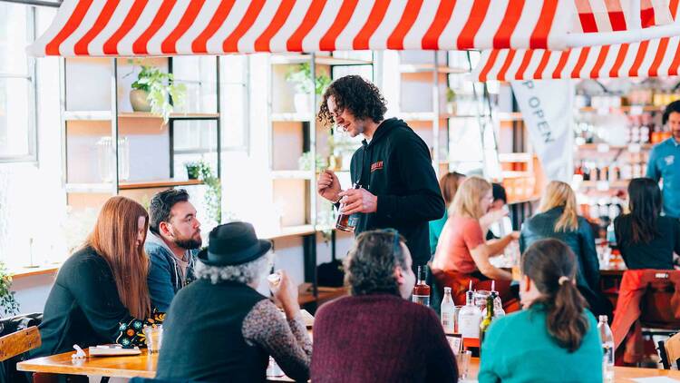 Gin expert speaking with market attendees.