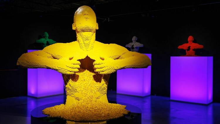 A giant yellow Lego sculpture of a person. 
